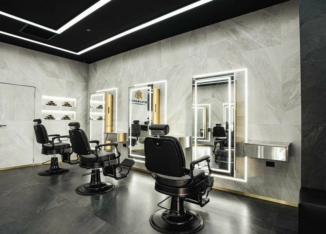 Modern interior of Royal Blends - Gregory Hills barbershop in Gledswood Hills, New South Wales, AU with sleek chairs.
