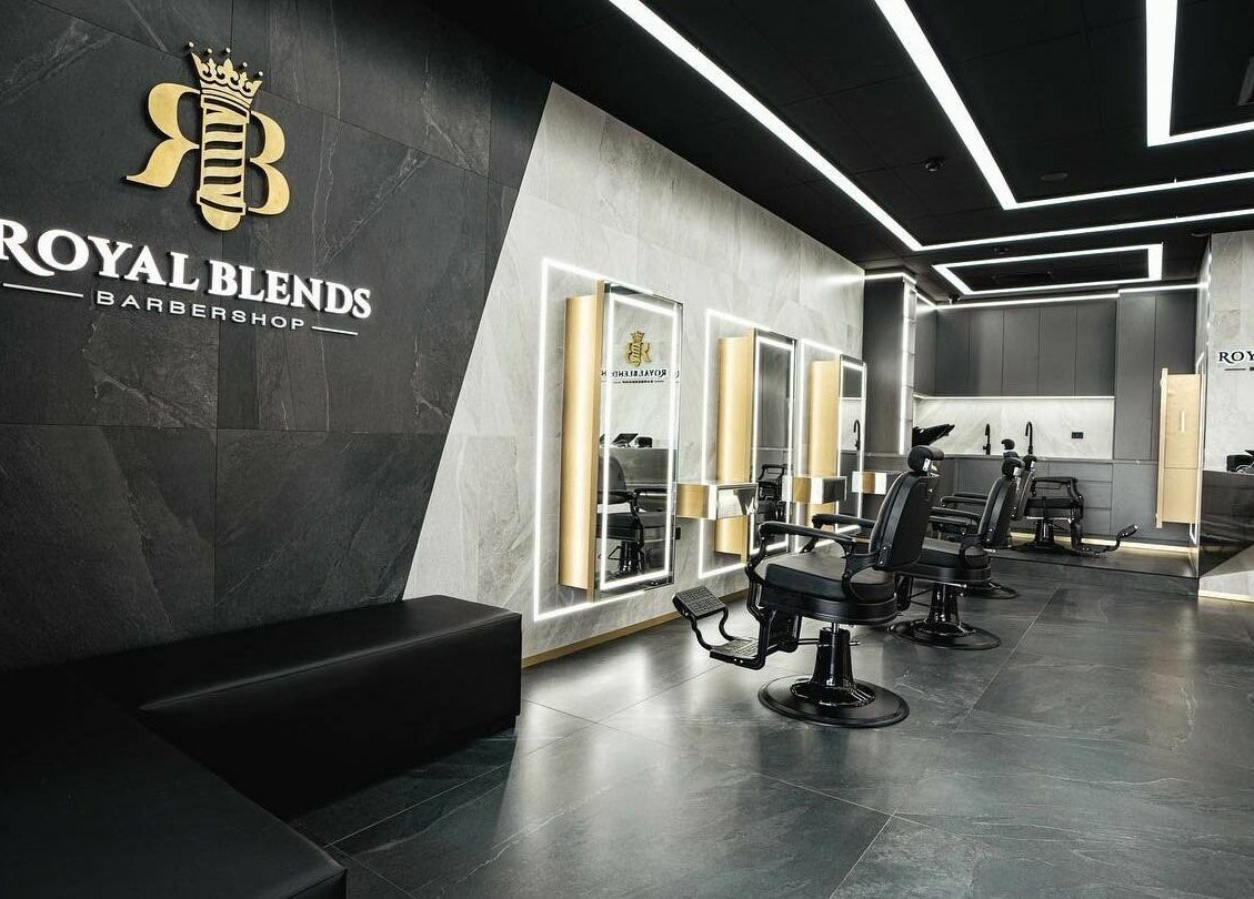 Luxurious interior of Royal Blends - Gregory Hills, Gledswood Hills, New South Wales, AU, featuring sleek barber chairs.