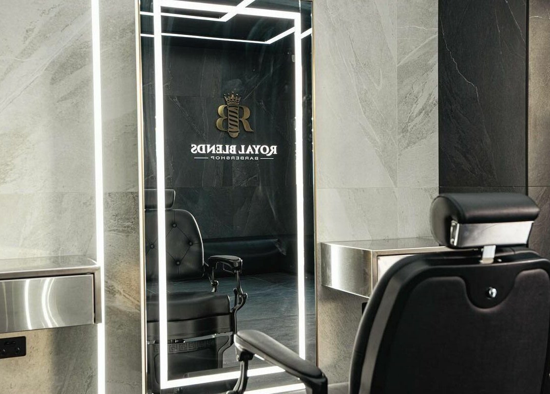 Luxurious barber chair at Royal Blends - Gregory Hills, Gledswood Hills, New South Wales, AU with sleek mirror.