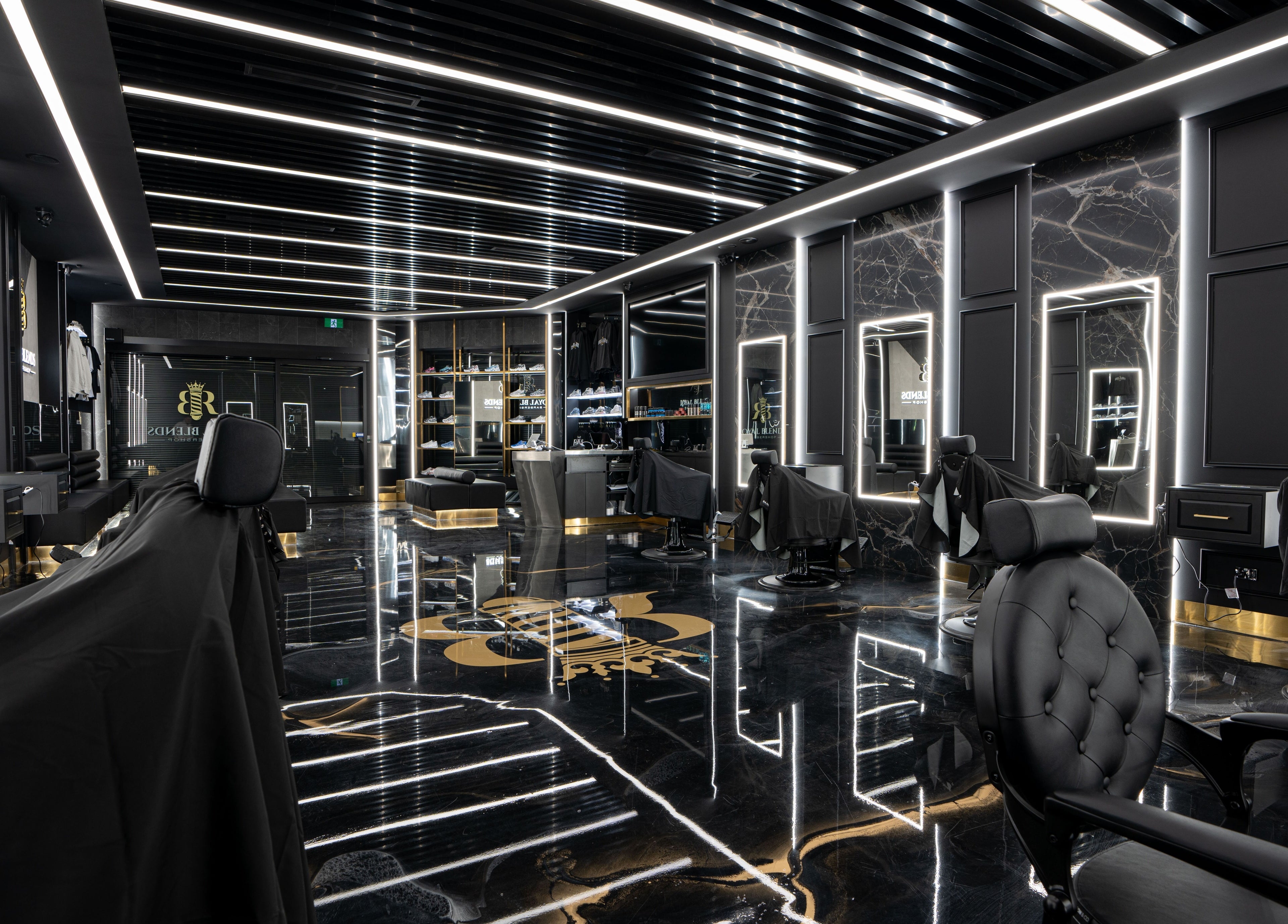 Interior of Royal Blends Barbershop Warwick Farm, New South Wales, AU; modern design with black and gold accents.