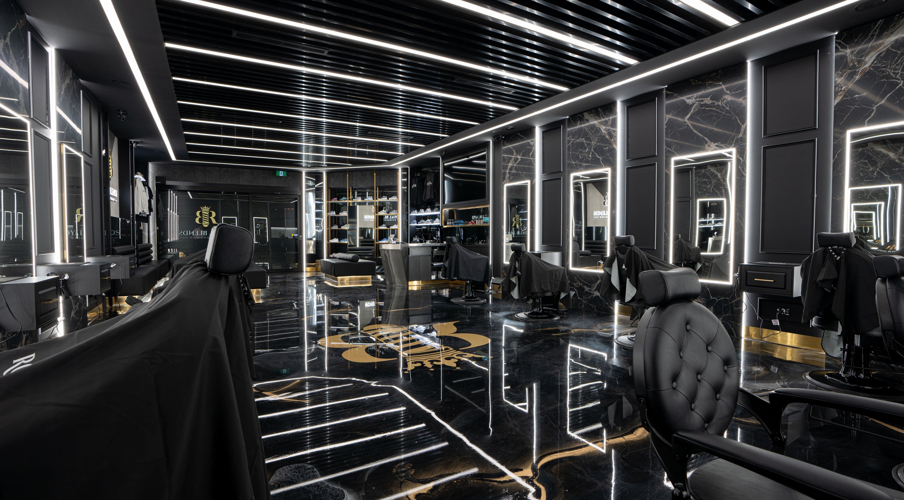 Interior of Royal Blends Barbershop Warwick Farm, New South Wales, AU; modern design with black and gold accents.