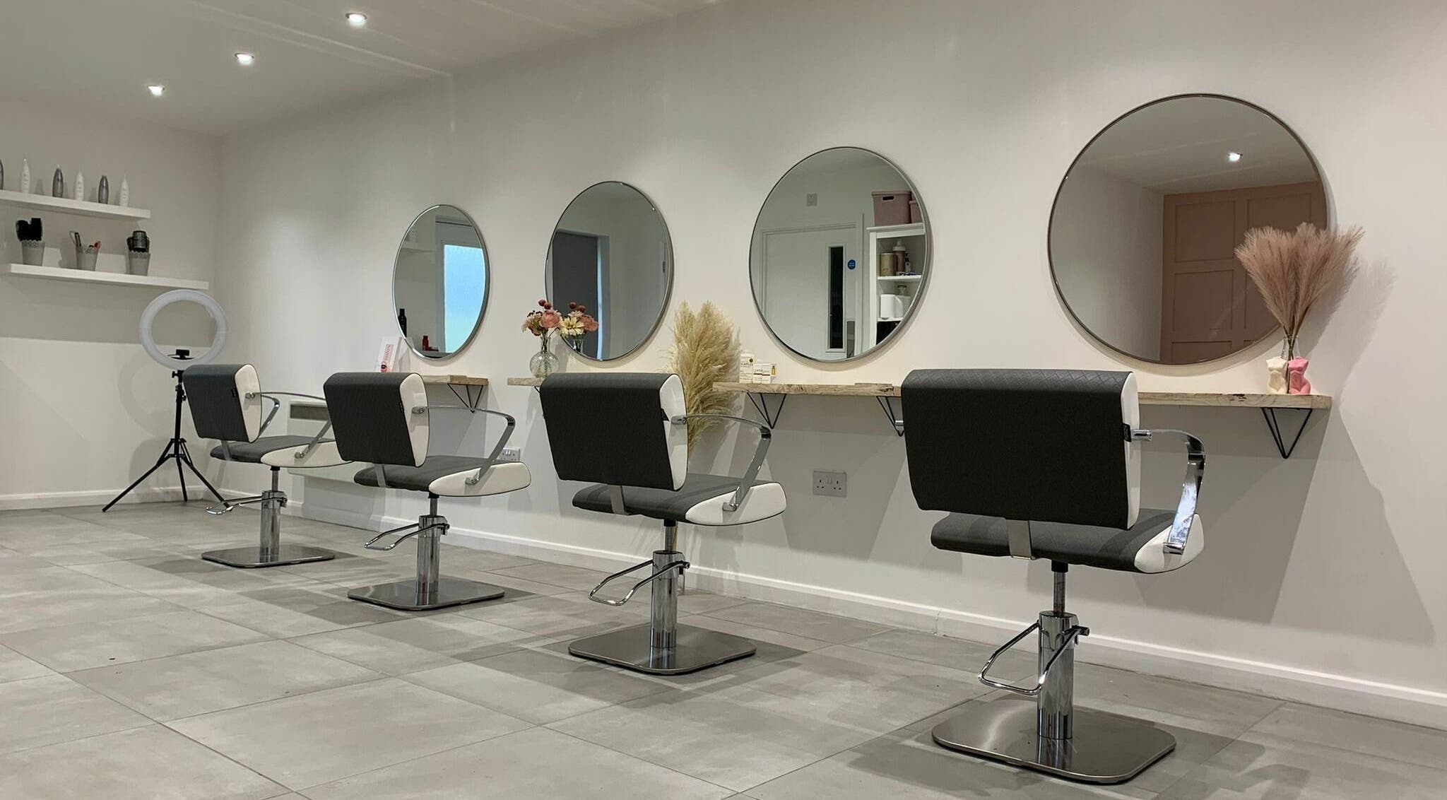 Bethany’s Hair Studio in Dudley, England, GB: modern salon chairs and round mirrors in stylish interior.
