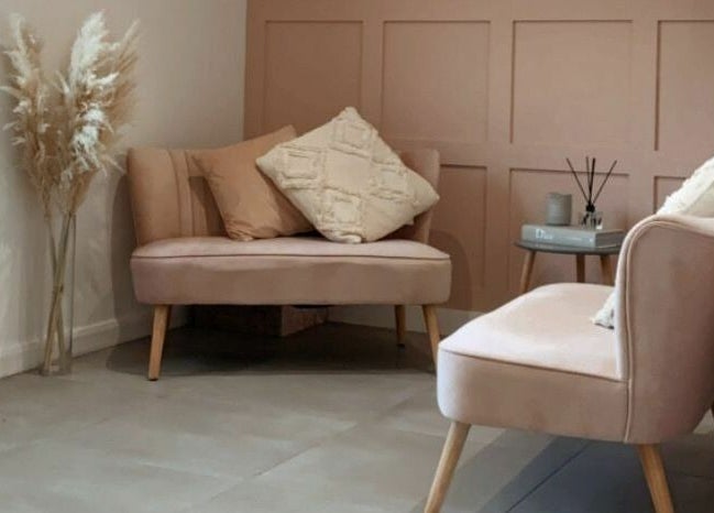 Chic seating area at Bethany’s Hair Studio, Dudley, England, GB, featuring stylish pink couches and decor.