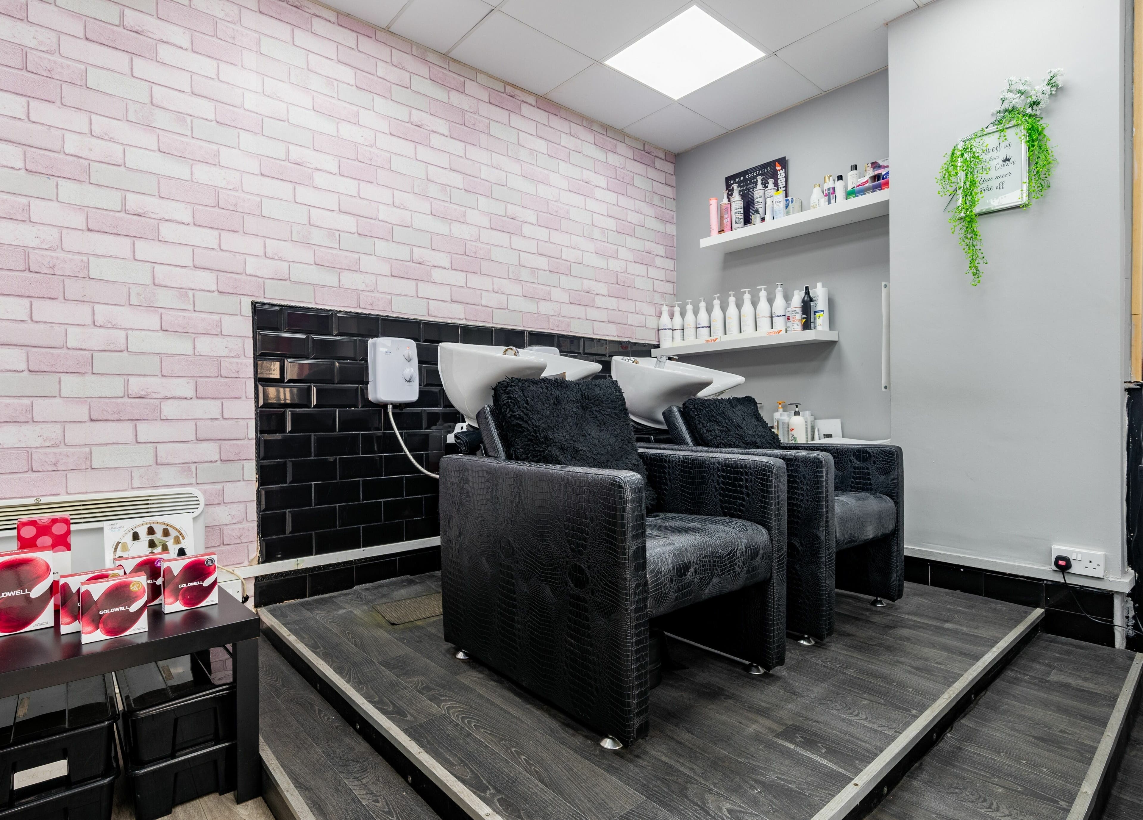 Chic hair wash area at Blown Away, Wythenshawe, England, GB, featuring elegant seating and hair care products.