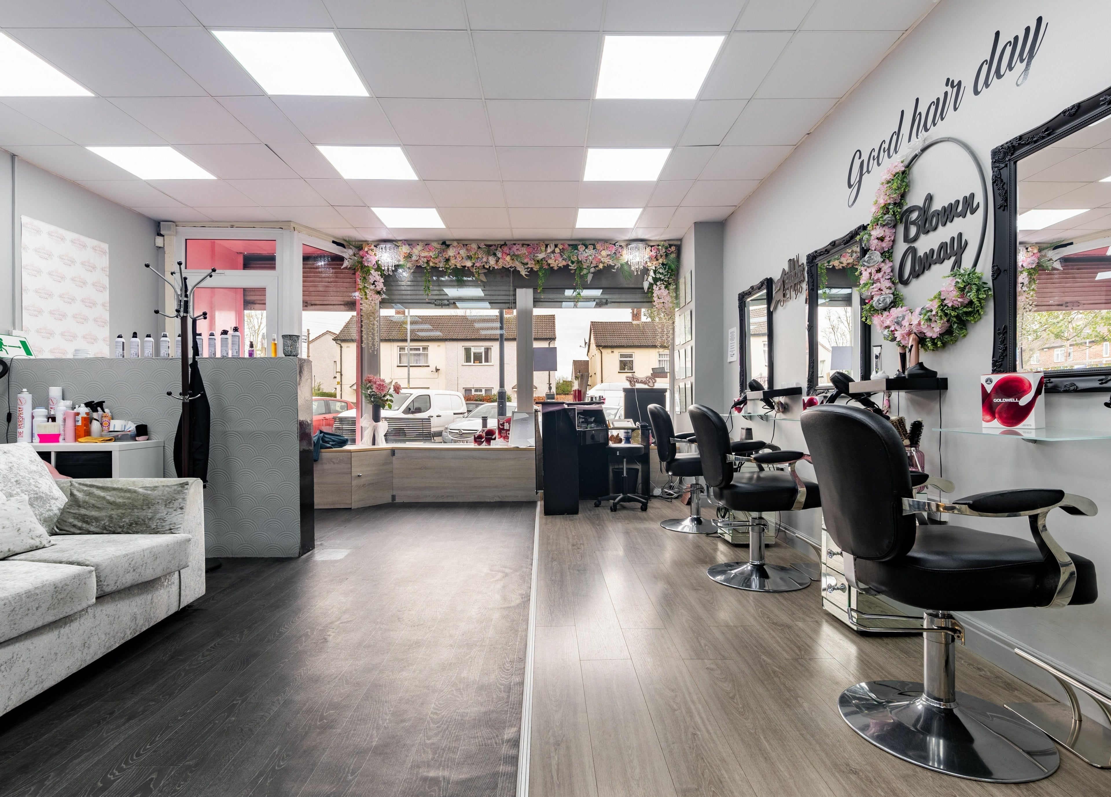 Interior of Blown Away salon in Wythenshawe, England, GB showcasing elegant styling chairs and decor.