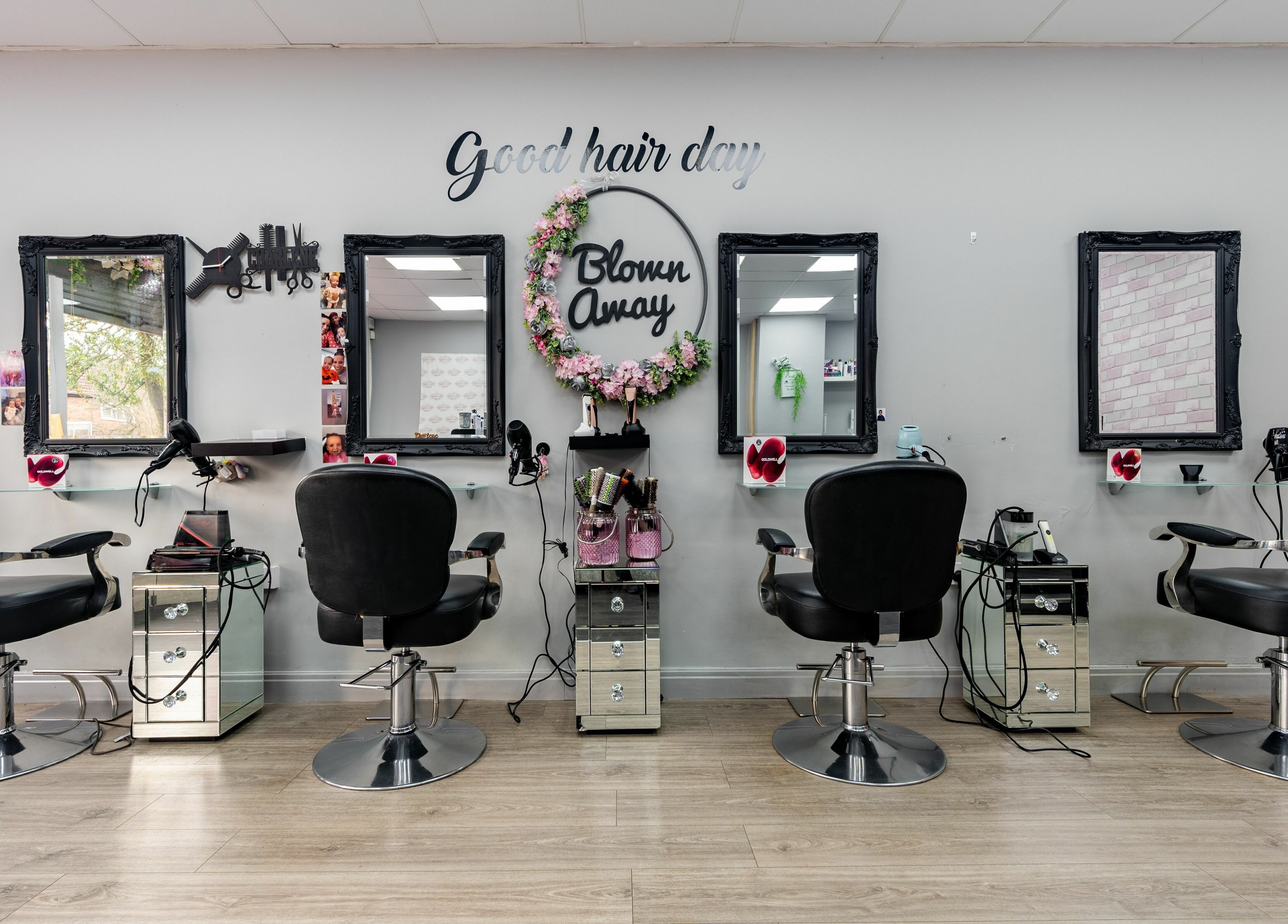 Chic salon seating at Blown Away in Wythenshawe, England, GB. Modern styling chairs and mirrors enhance the aesthetic.