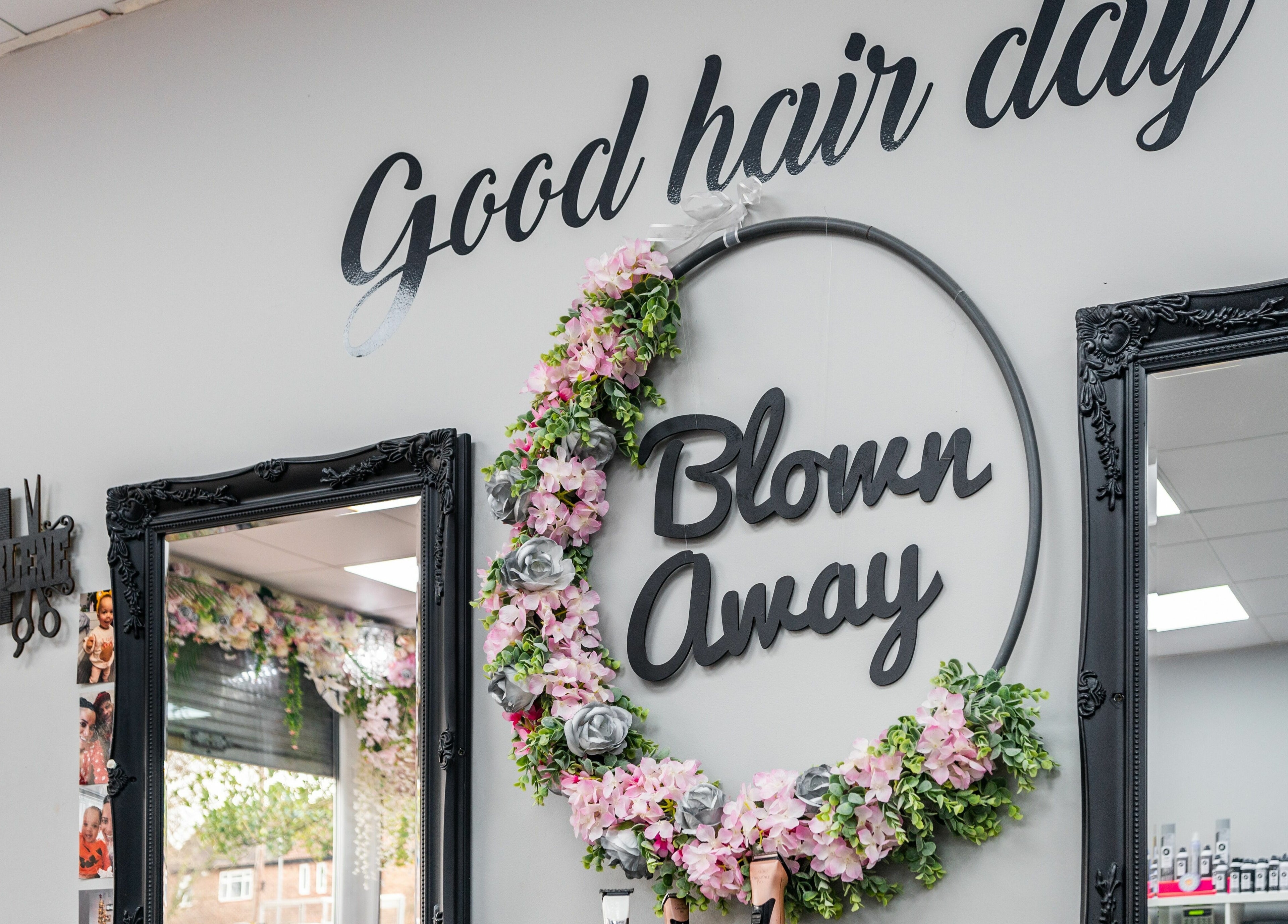 Interior of Blown Away in Wythenshawe, England featuring stylish flower decor and mirrors.