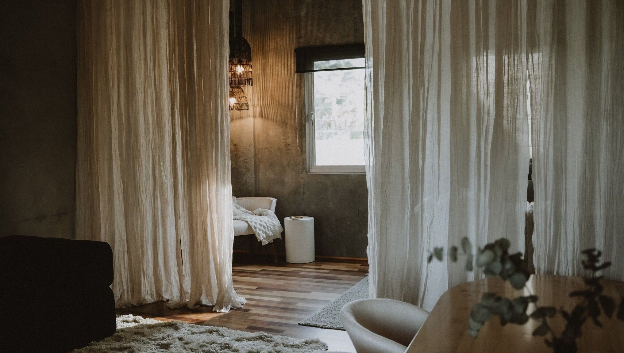 Calming interior of UMICA, Byron Bay, New South Wales, AU featuring soft drapes and warm lighting.
