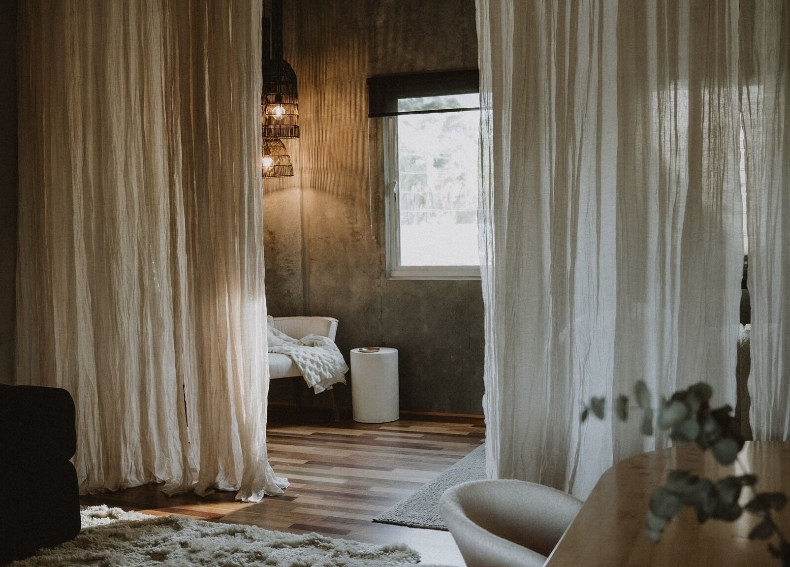 Calming interior of UMICA, Byron Bay, New South Wales, AU featuring soft drapes and warm lighting.