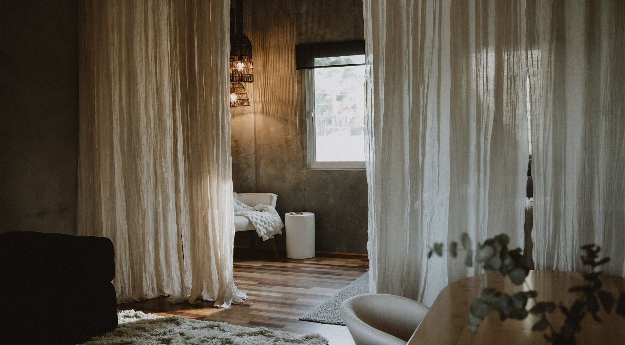 Calming interior of UMICA, Byron Bay, New South Wales, AU featuring soft drapes and warm lighting.