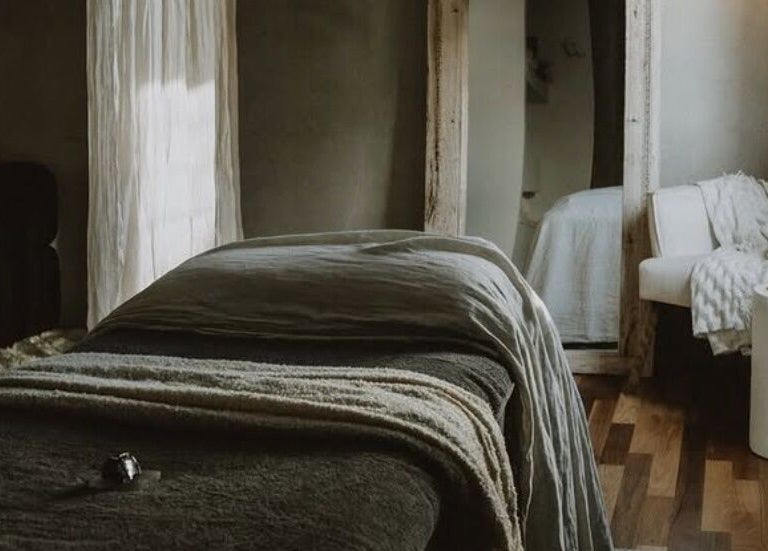 Luxurious massage room at UMICA in Byron Bay, New South Wales, AU with cozy furnishings and soft lighting.