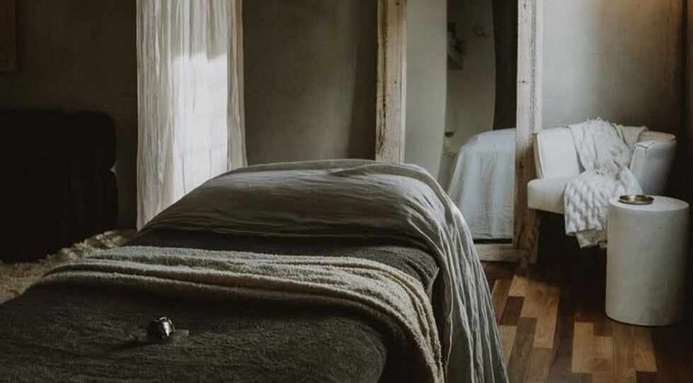 Luxurious massage room at UMICA in Byron Bay, New South Wales, AU with cozy furnishings and soft lighting.