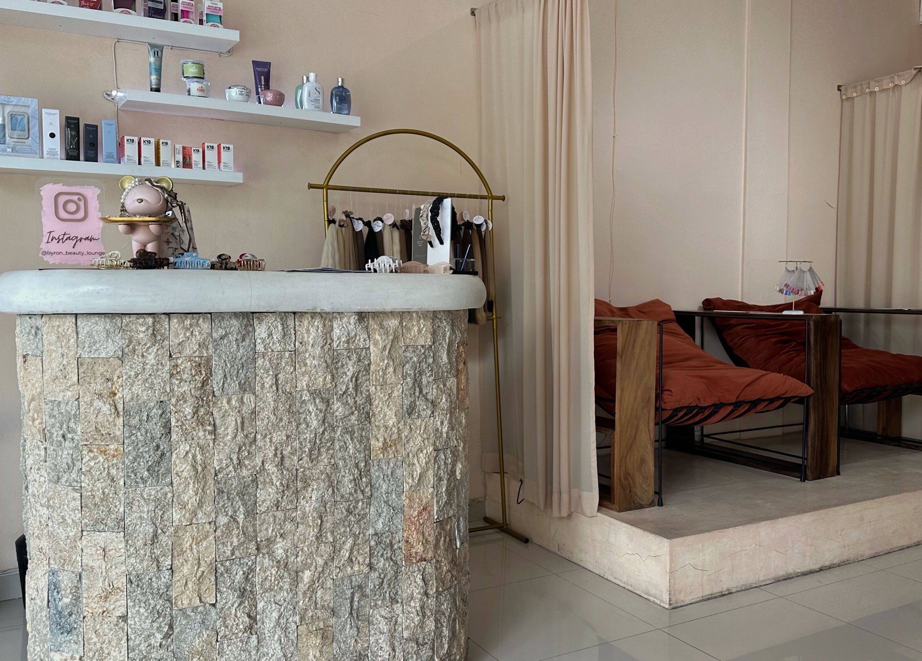 Stylish reception at Byron Beauty Lounge in Bali, Bali, ID with cozy seating and product displays.