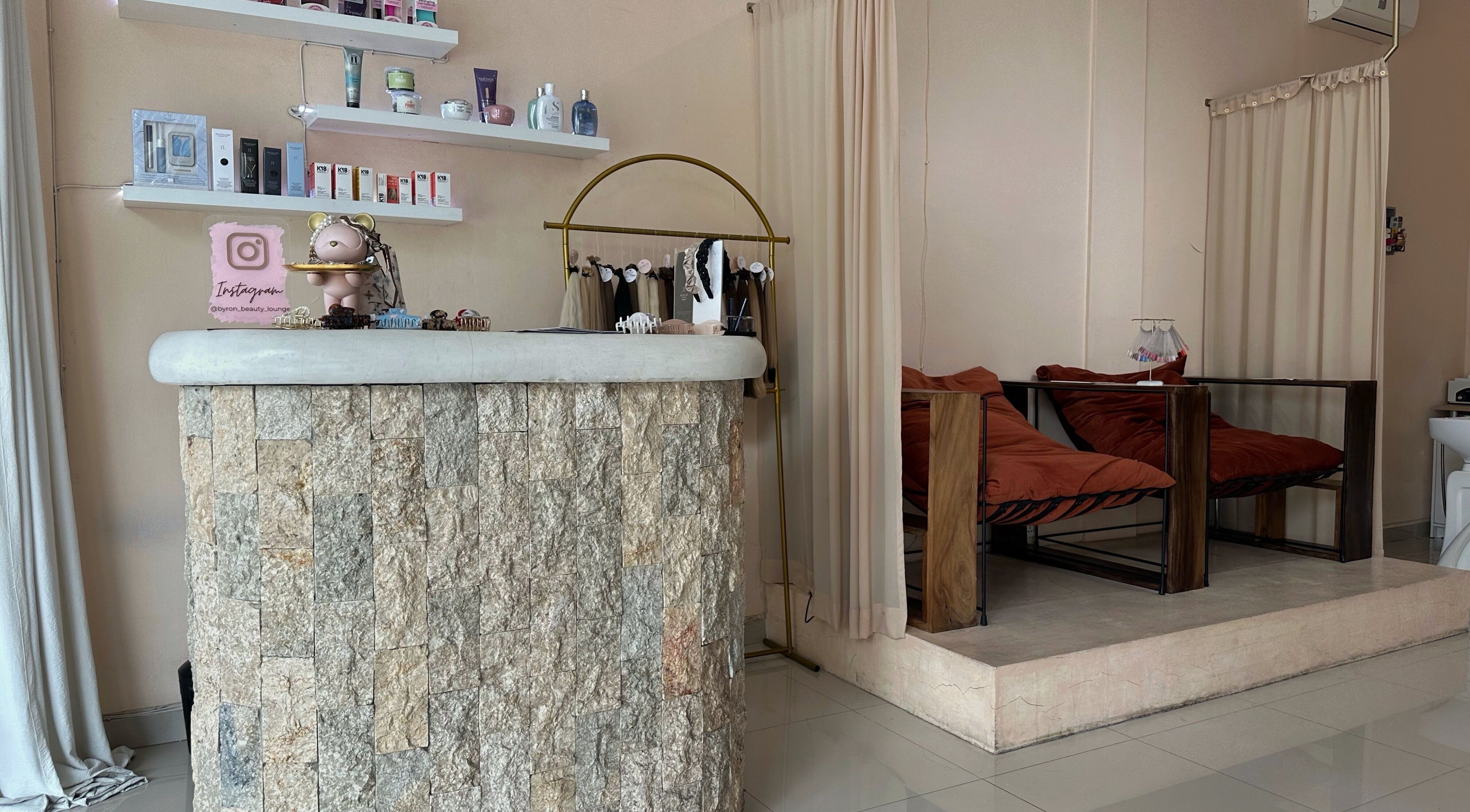 Stylish reception at Byron Beauty Lounge in Bali, Bali, ID with cozy seating and product displays.