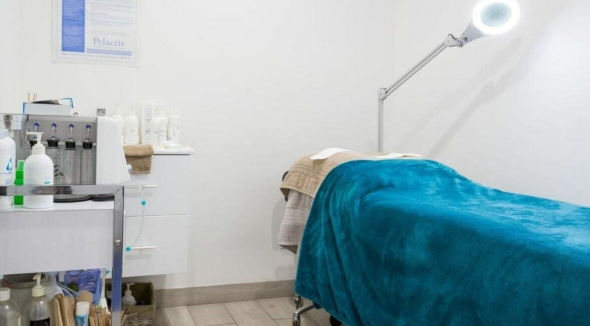 Relaxing treatment room at Bare Body Beauty & Laser, Woollahra, New South Wales, AU, featuring a cozy massage table.