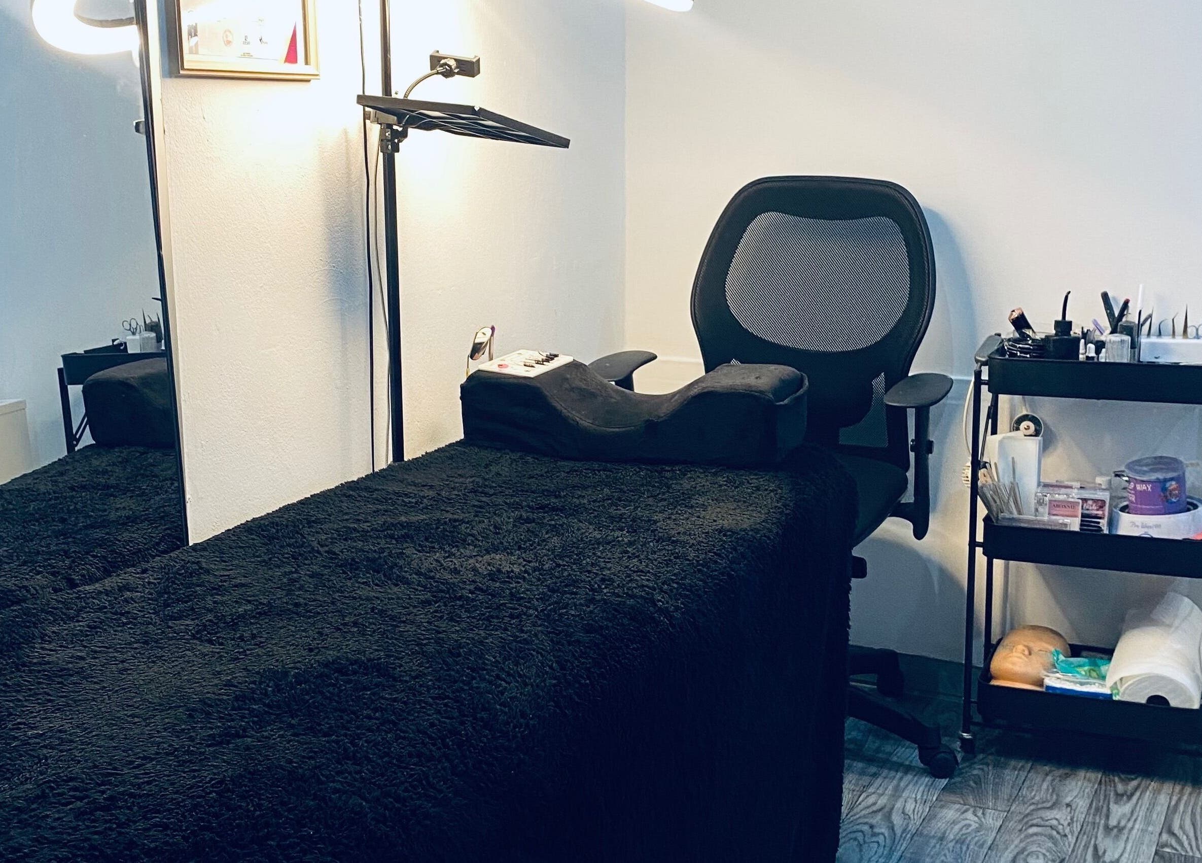 Cozy treatment room at Blackdime Beauty Bar, Johannesburg, Gauteng, ZA with a plush bed and beauty tools.