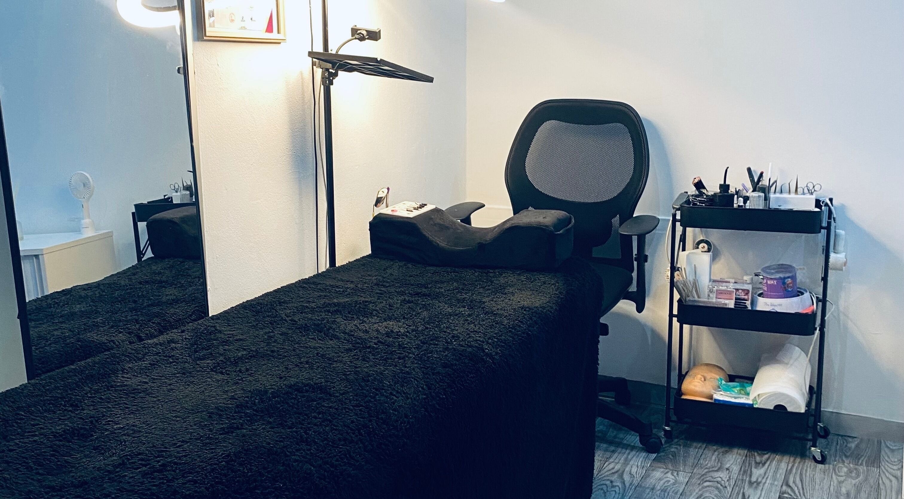 Cozy treatment room at Blackdime Beauty Bar, Johannesburg, Gauteng, ZA with a plush bed and beauty tools.