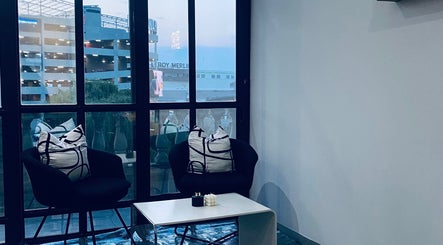 Chic lounge area at Blackdime Beauty Bar, Johannesburg, Gauteng, ZA with modern decor and ample window light.