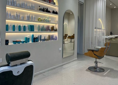 Elegant salon setup at RM The Studio, Melbourne, Victoria, AU, featuring stylish chairs and product shelves.