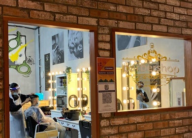 Interior of BT Barbershop The Sphere in Kuala Lumpur showcasing stylish decor and a client in service.