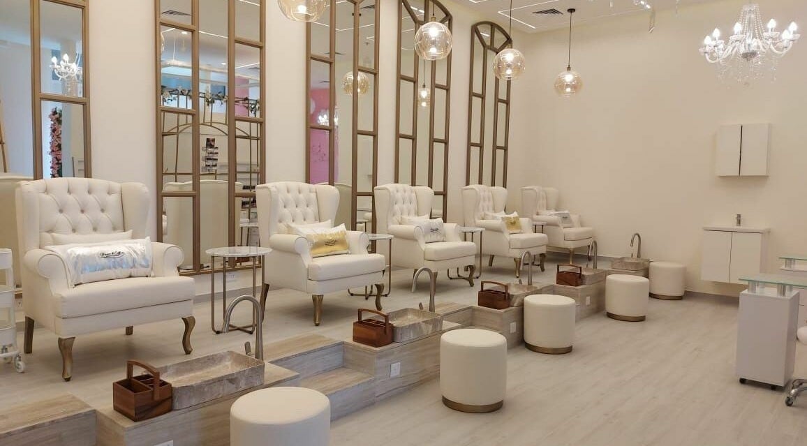 Luxurious pedicure stations at Maison De Coiffure Beauty Lounge, Dubai, AE with elegant chairs and lighting.