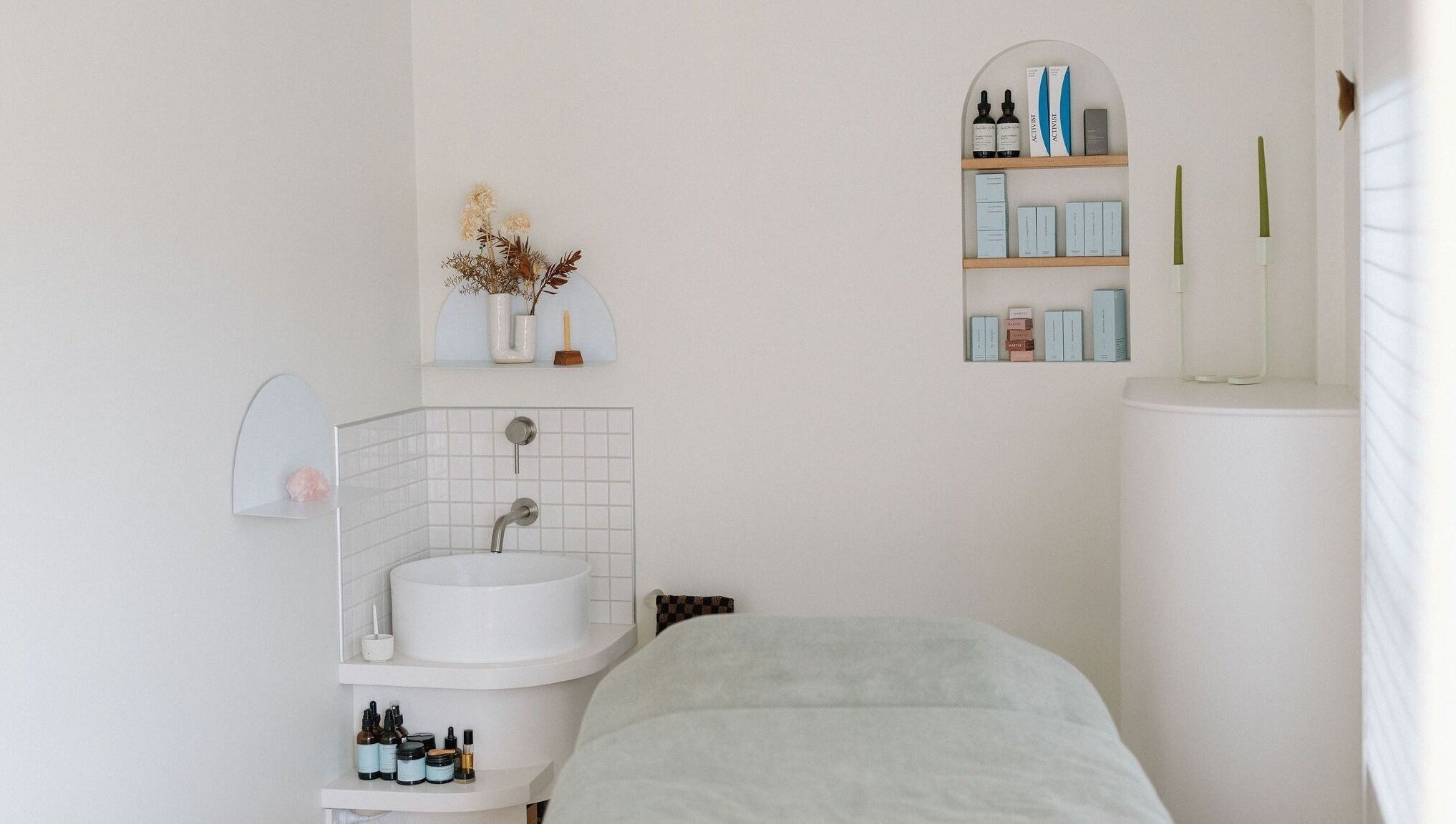Tranquil treatment room at Innerbloom Holistic Skin Studio, Auckland, Auckland, NZ with modern decor and skincare products.