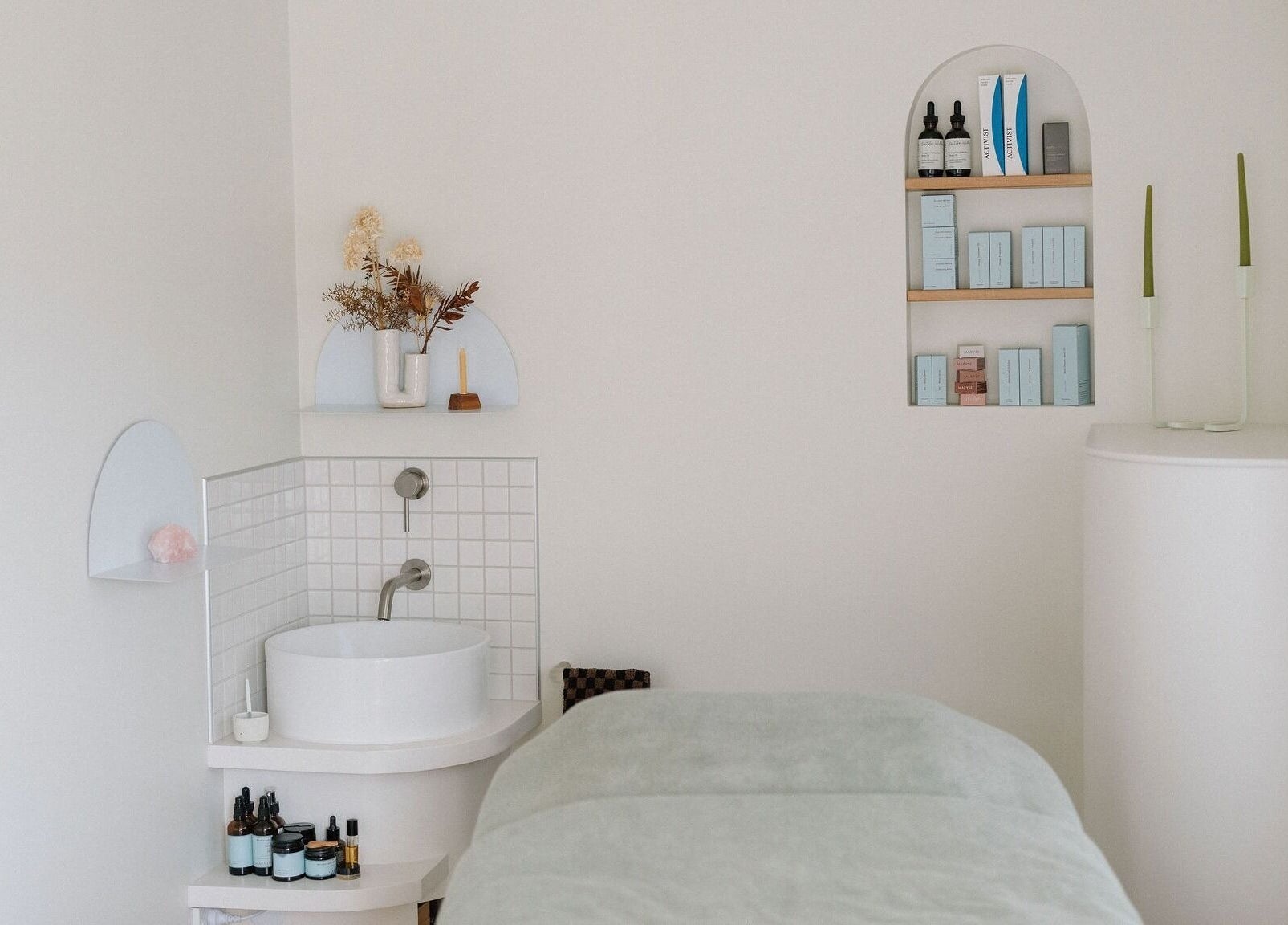 Tranquil treatment room at Innerbloom Holistic Skin Studio, Auckland, Auckland, NZ with modern decor and skincare products.