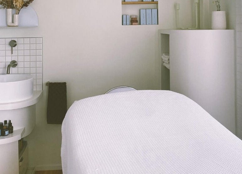 Calm treatment room at Innerbloom Holistic Skin Studio, Auckland, Auckland, NZ. Features a massage bed and sink.