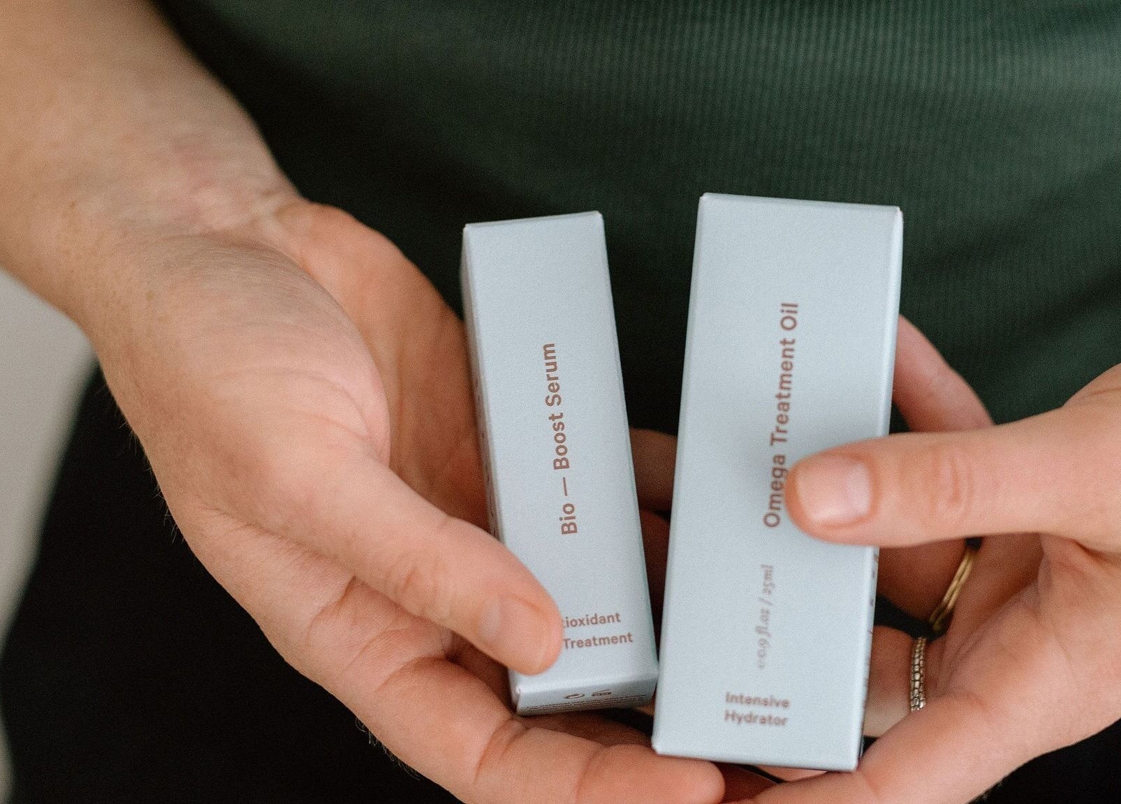 Hands holding skincare products at Innerbloom Holistic Skin Studio, Auckland, Auckland, NZ.