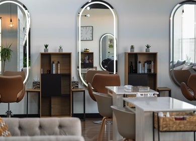 Chic interior of Nev & Svet Hair Studio in Dubai, Dubai, AE featuring modern seating and decor.