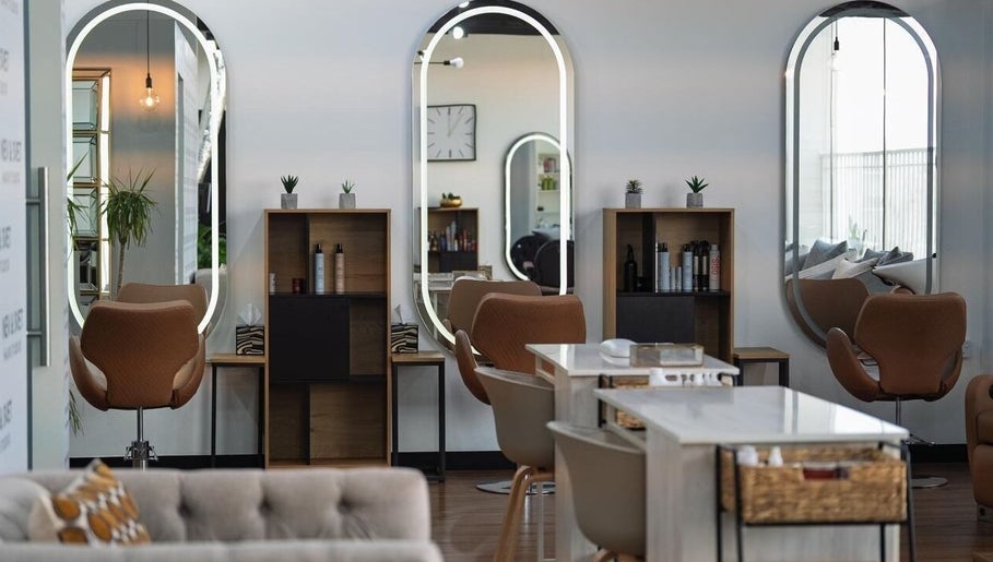 Modern interior of Nev & Svet Hair Studio in Dubai, Dubai, AE, featuring stylish mirrors and chairs.