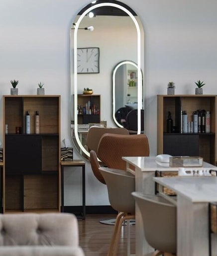 Modern interior of Nev & Svet Hair Studio in Dubai, Dubai, AE, featuring stylish mirrors and chairs.