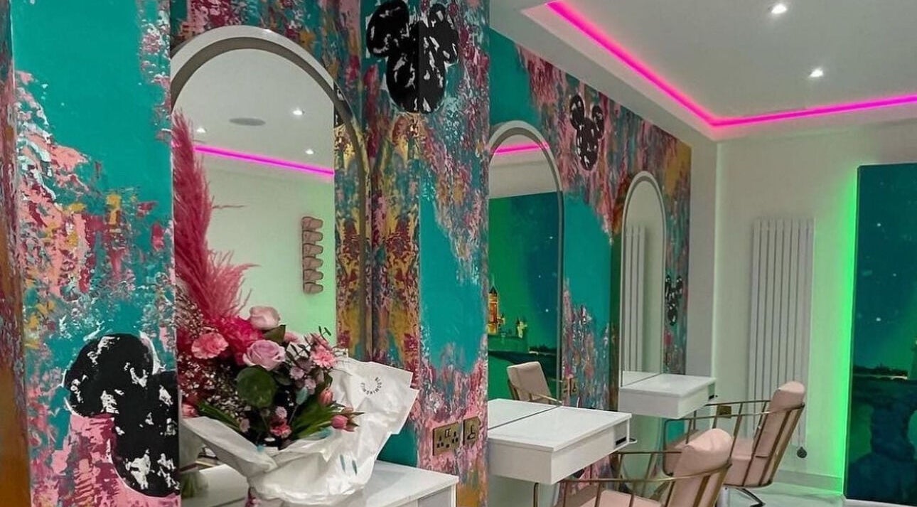 Vibrant salon with floral decor at Hairbyneveswan, Dundee, Scotland, GB. Modern styling chairs and colorful walls.