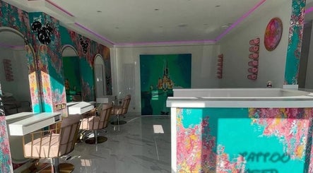 Vibrant interior of Hairbyneveswan salon in Dundee, Scotland, GB with colorful walls and modern styling chairs.
