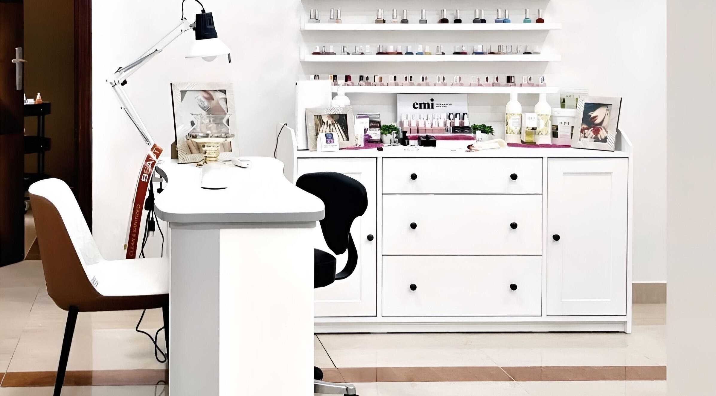 Nail station at Beauty Room Salon in Dibba, AE, featuring a sleek design with nail polish display.