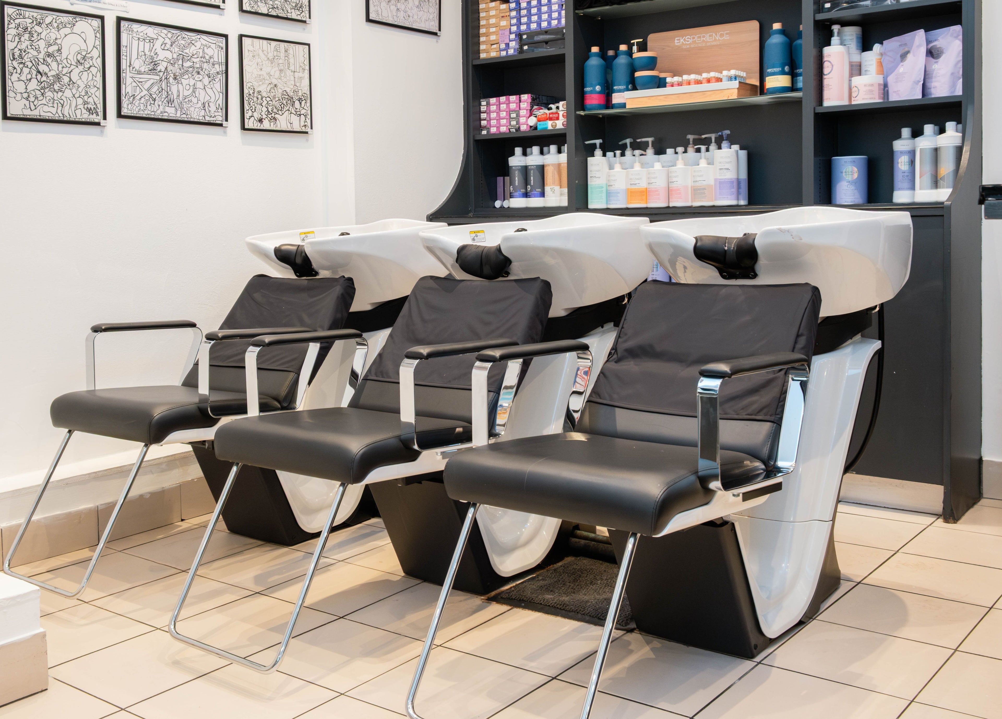 Sleek wash stations at Andrew Jose salon in London, England, GB with stylish chairs and modern decor.