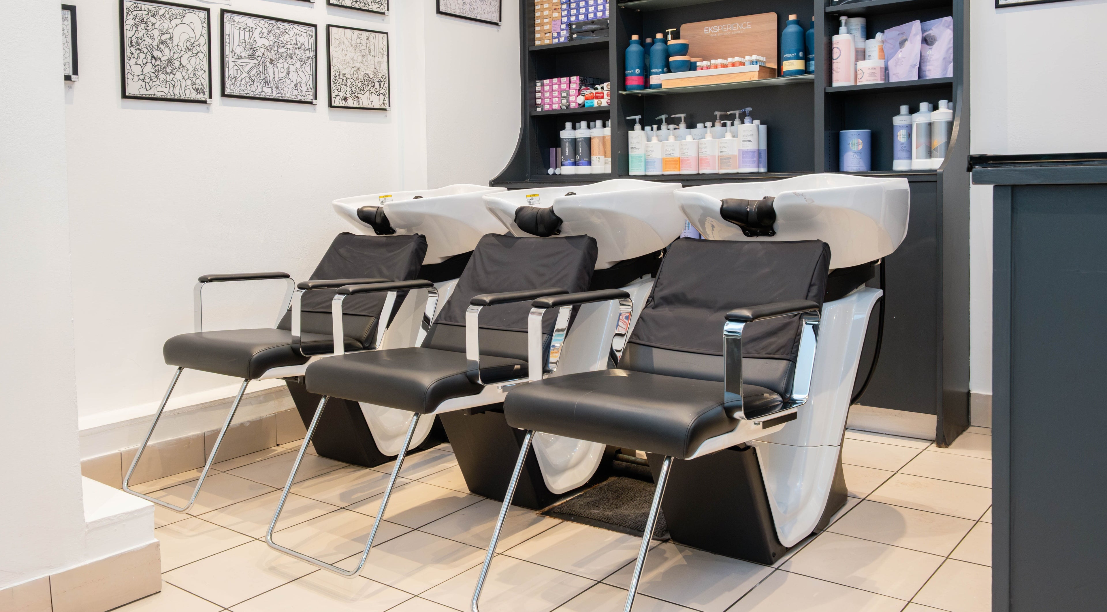 Sleek wash stations at Andrew Jose salon in London, England, GB with stylish chairs and modern decor.
