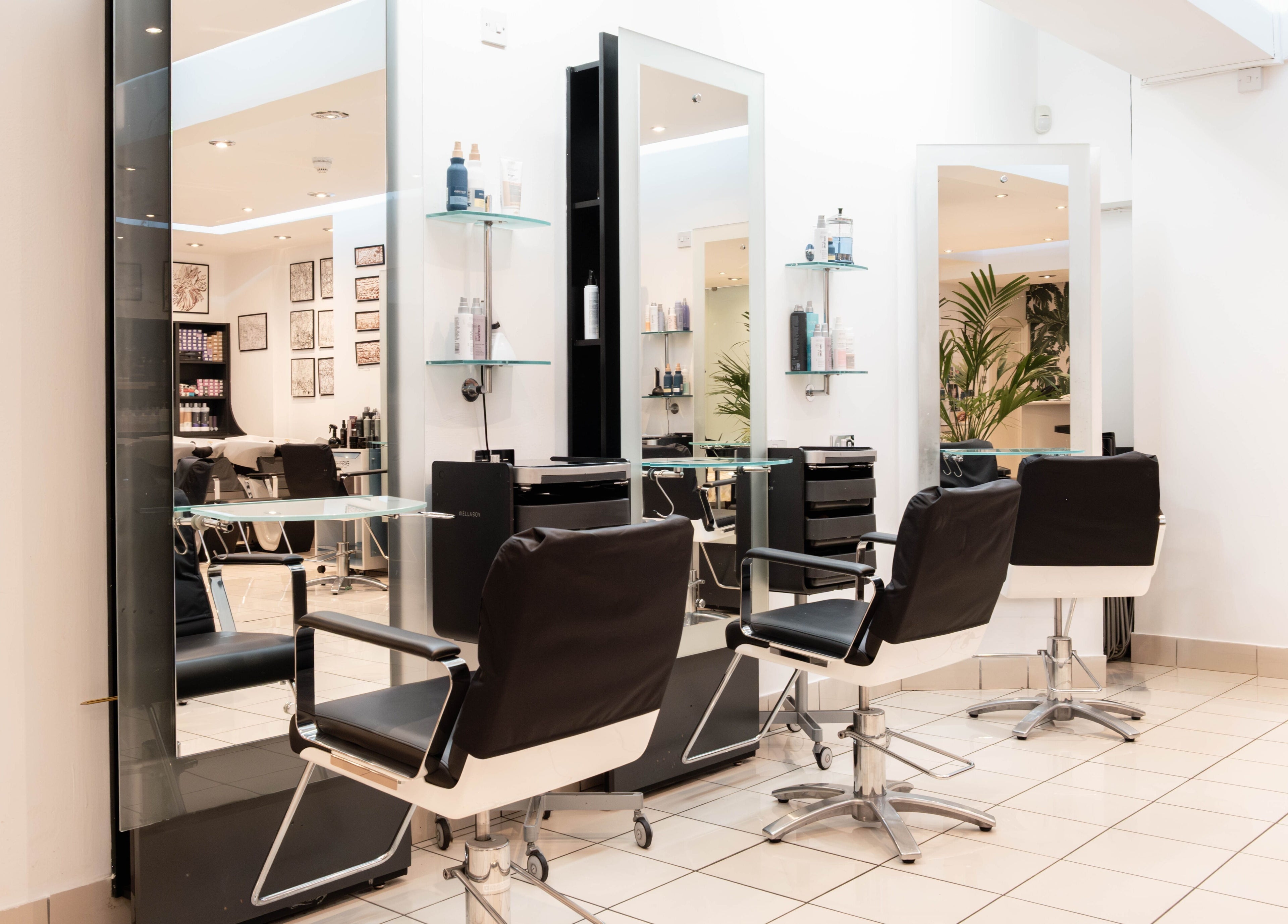 Modern salon setup at Andrew Jose in London, England, GB, with sleek chairs and stylish decor.
