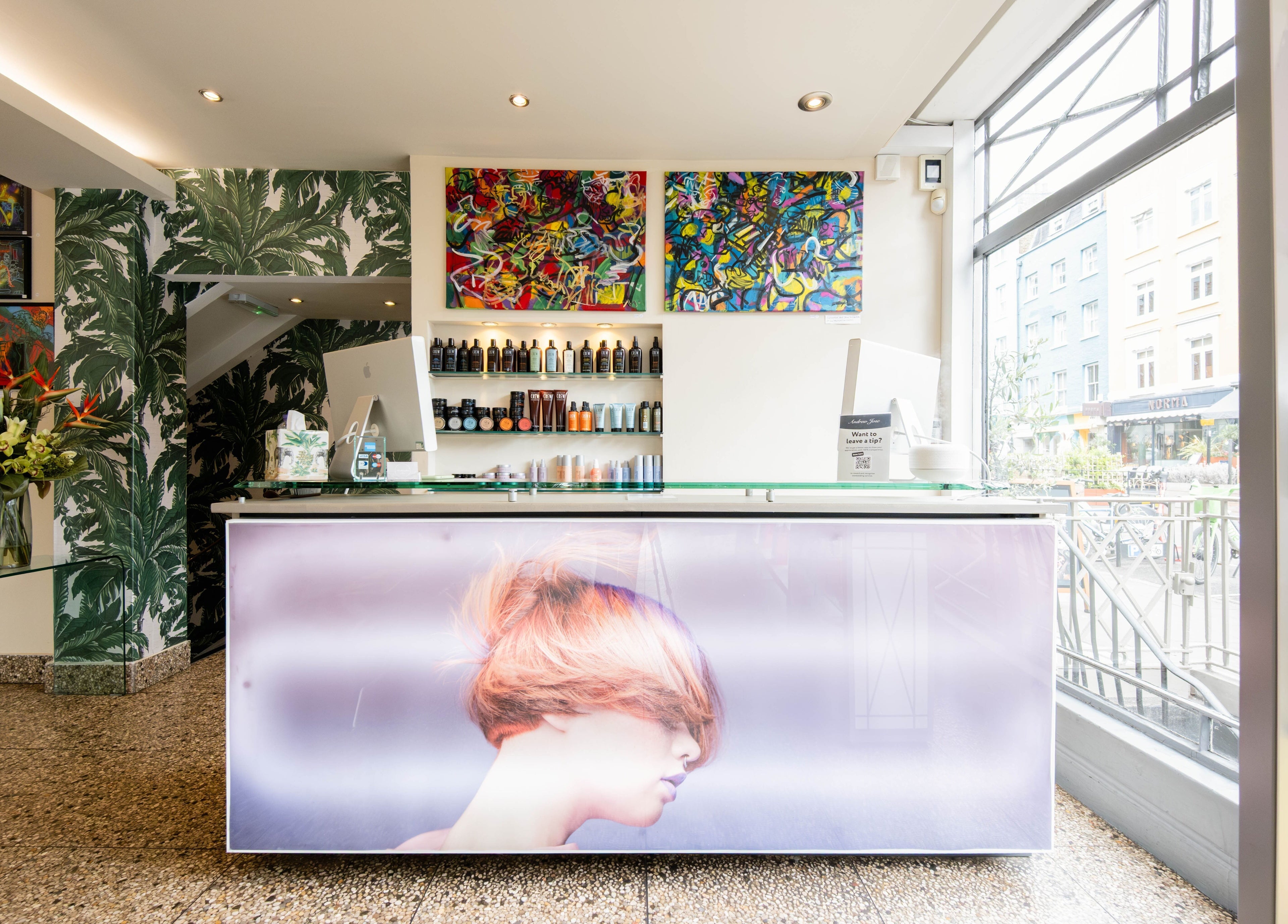 Modern reception at Andrew Jose in London, England, GB, showcasing vibrant art and products.