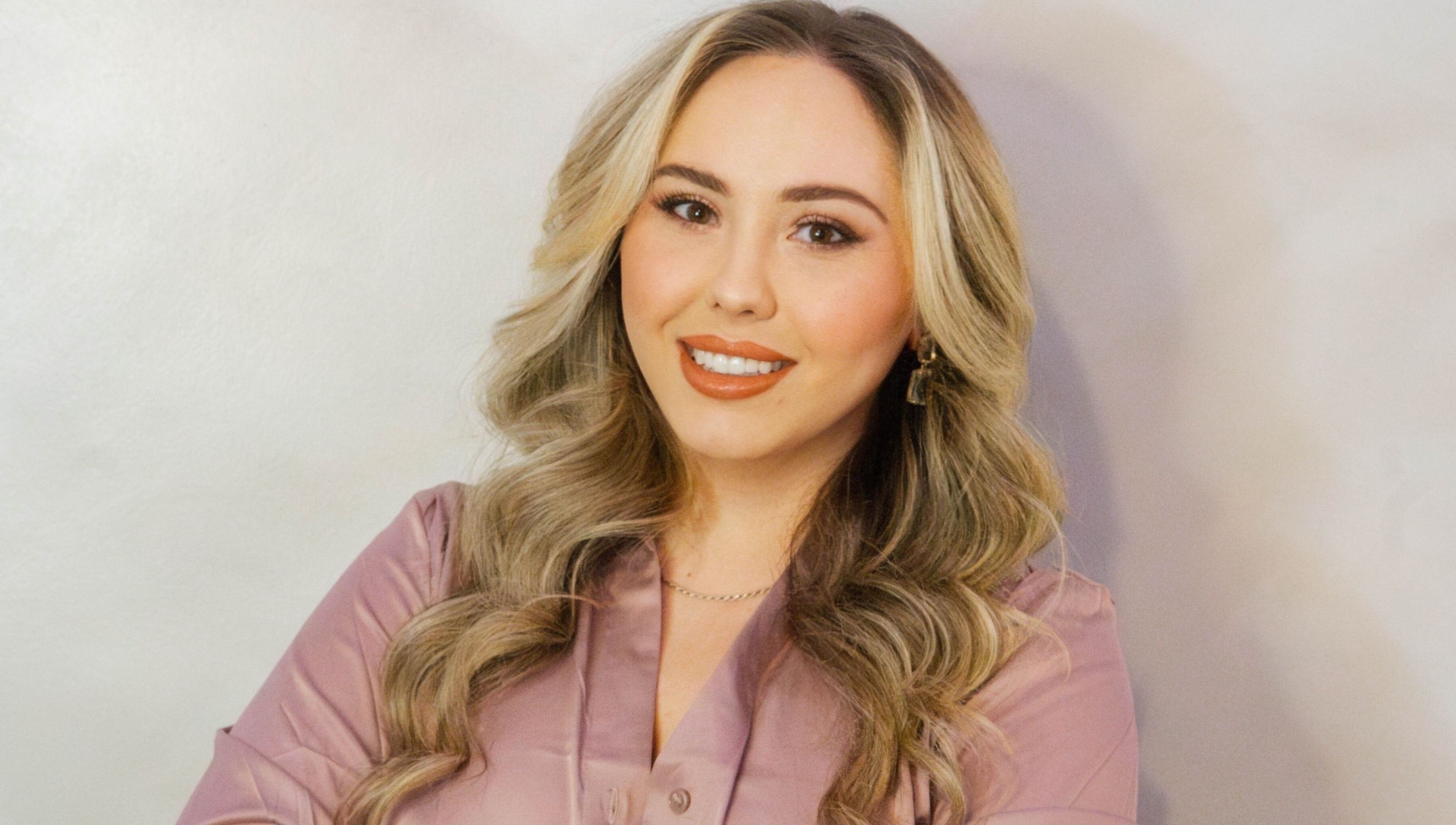 Professional at Angel Aesthetics by Angelina in Biloxi, Mississippi, US, smiling warmly in a serene setting.