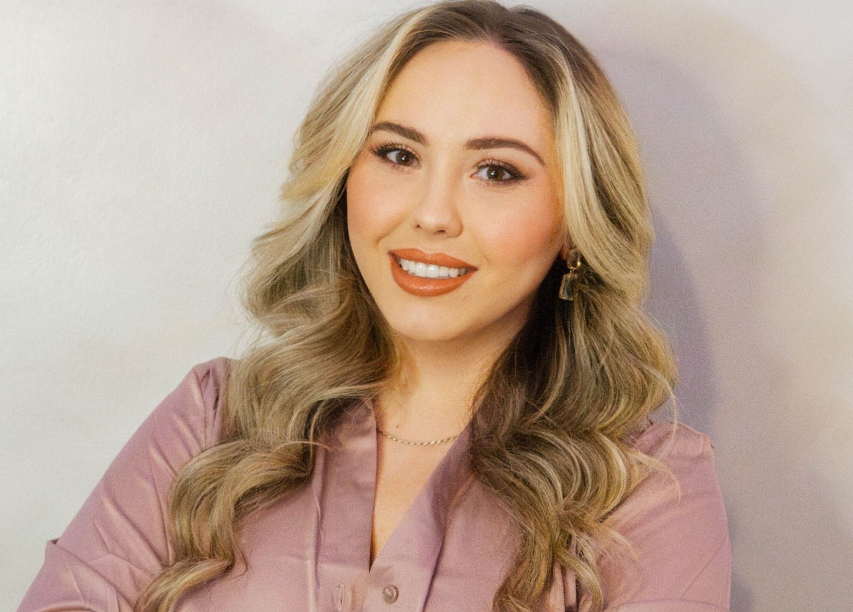 Professional at Angel Aesthetics by Angelina in Biloxi, Mississippi, US, smiling warmly in a serene setting.