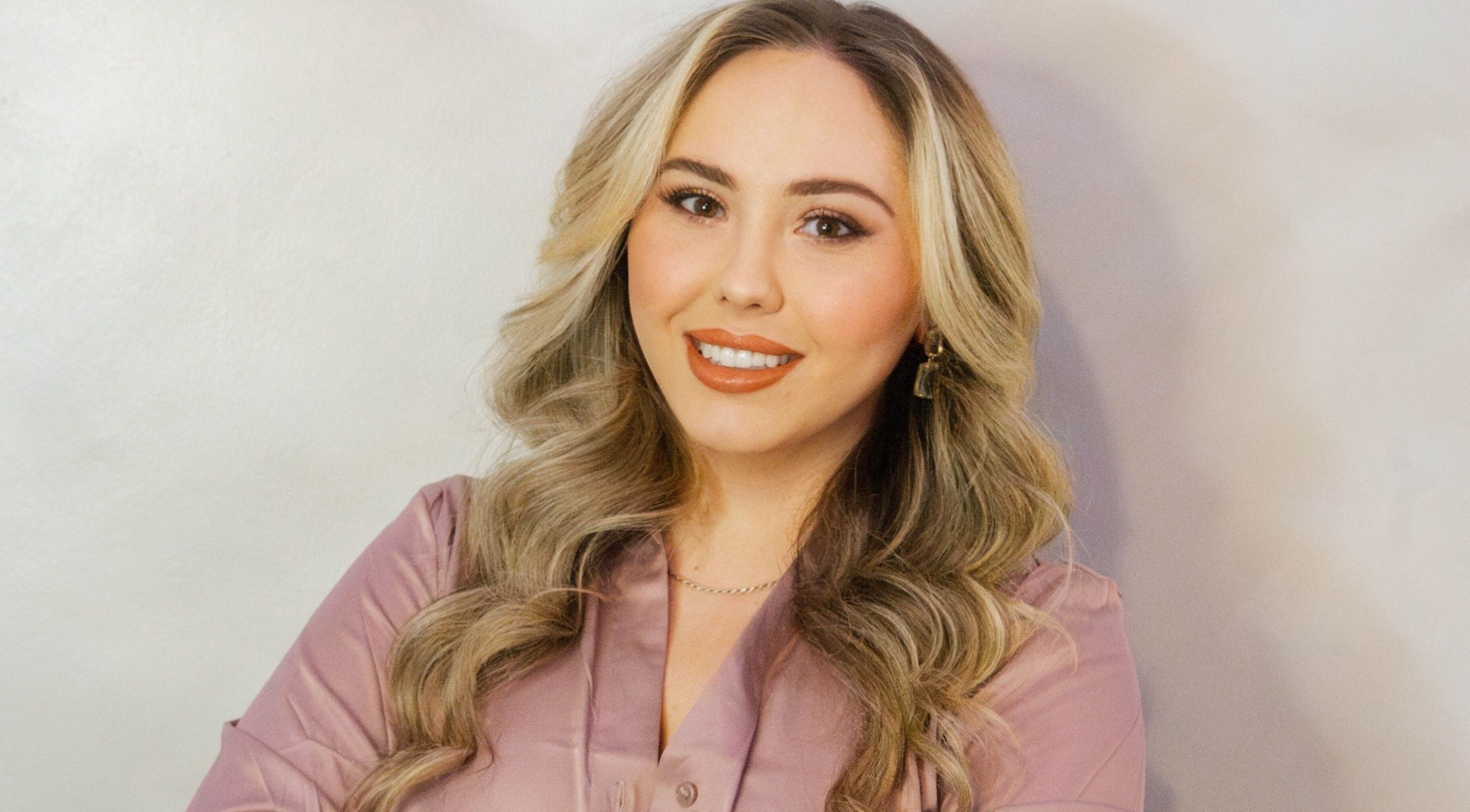 Professional at Angel Aesthetics by Angelina in Biloxi, Mississippi, US, smiling warmly in a serene setting.