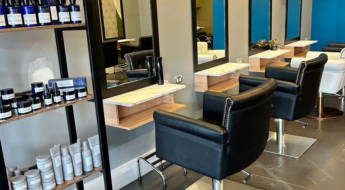 Stylish salon setup at Divine Hair and Co, Melbourne, Victoria, AU with luxury chairs and product shelves.