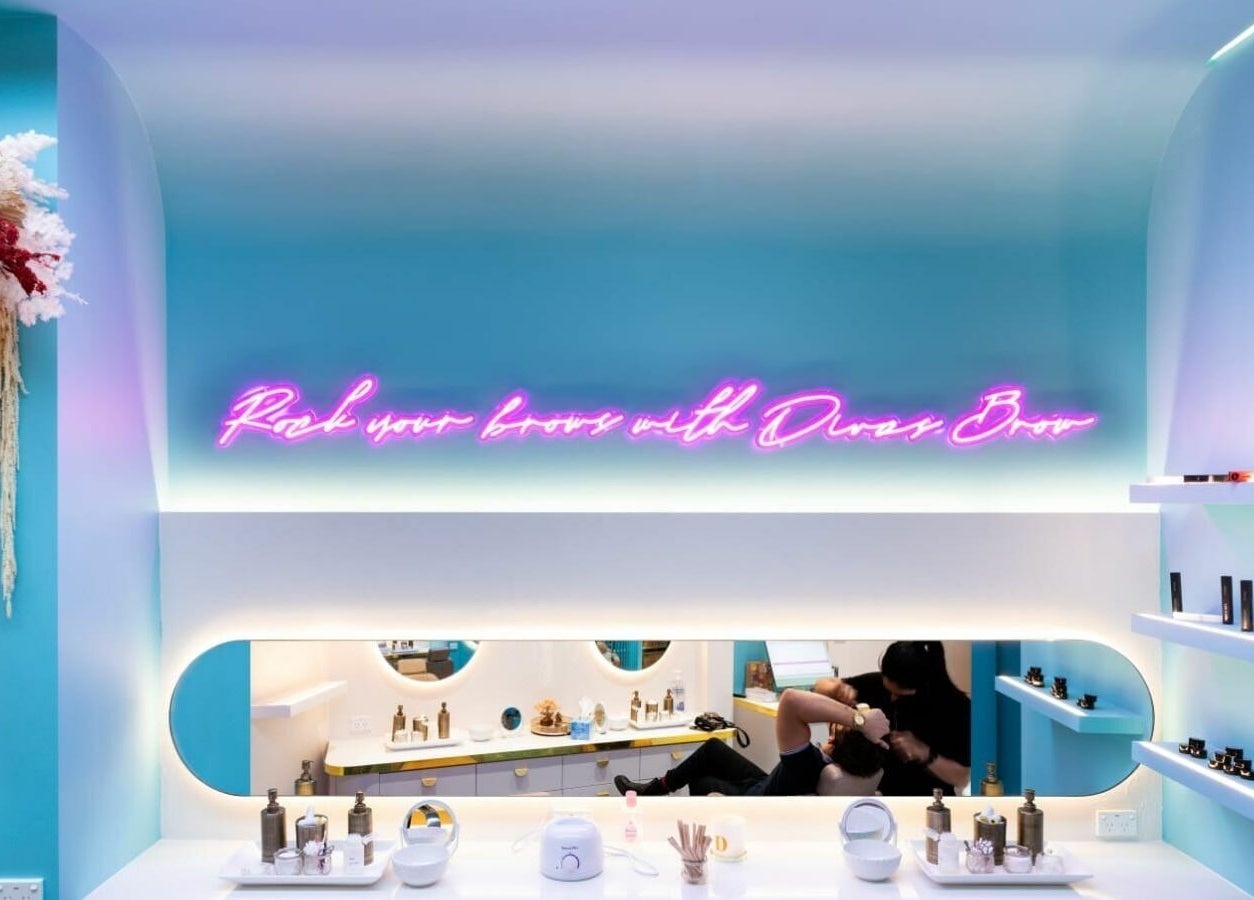 Interior of Divas Brow Eastgardens, featuring neon sign and beauty products in Eastgardens, New South Wales, AU.