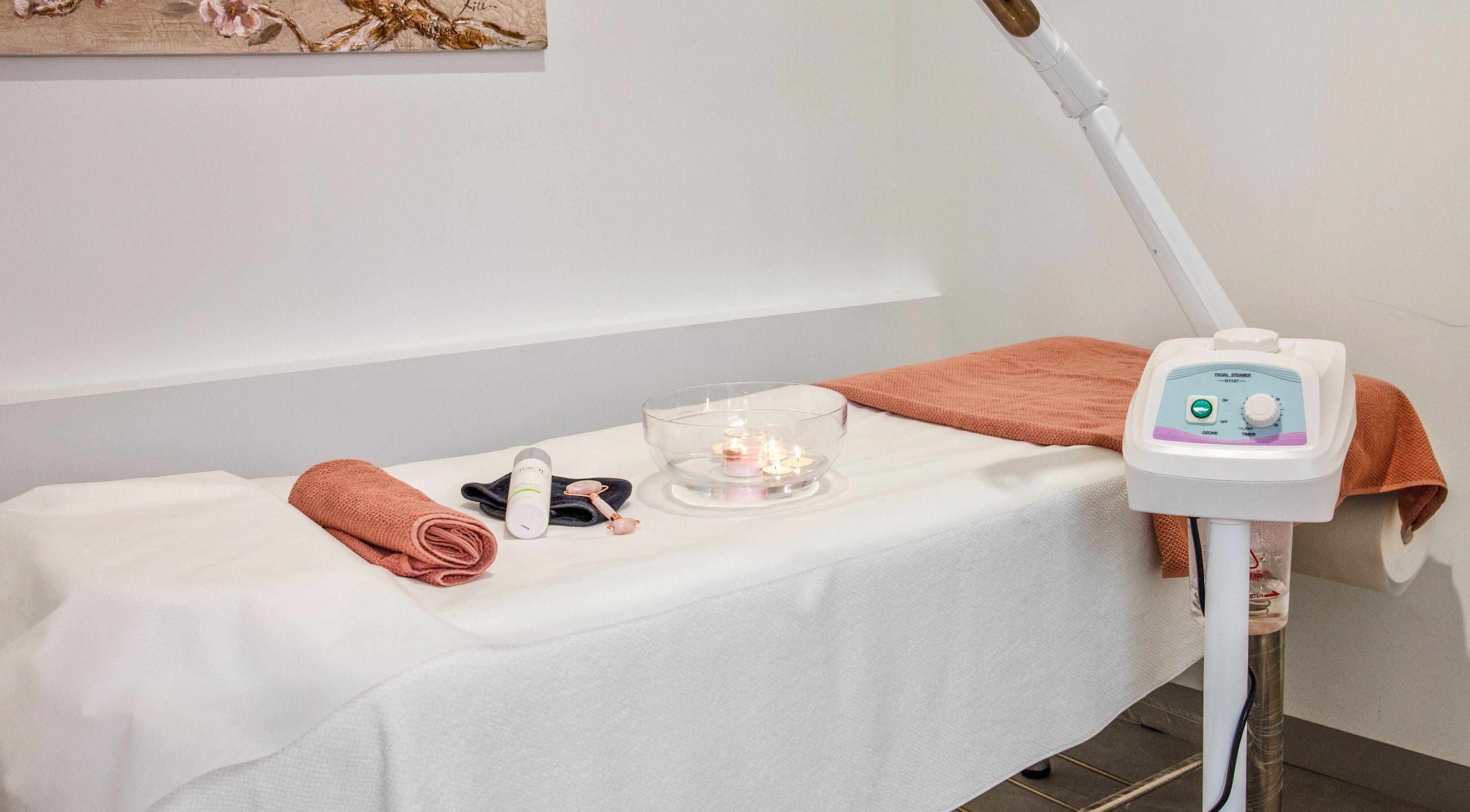 Relaxing spa treatment area at Divas Brow Warringah Mall, Brookvale, New South Wales, AU with candles and towels.