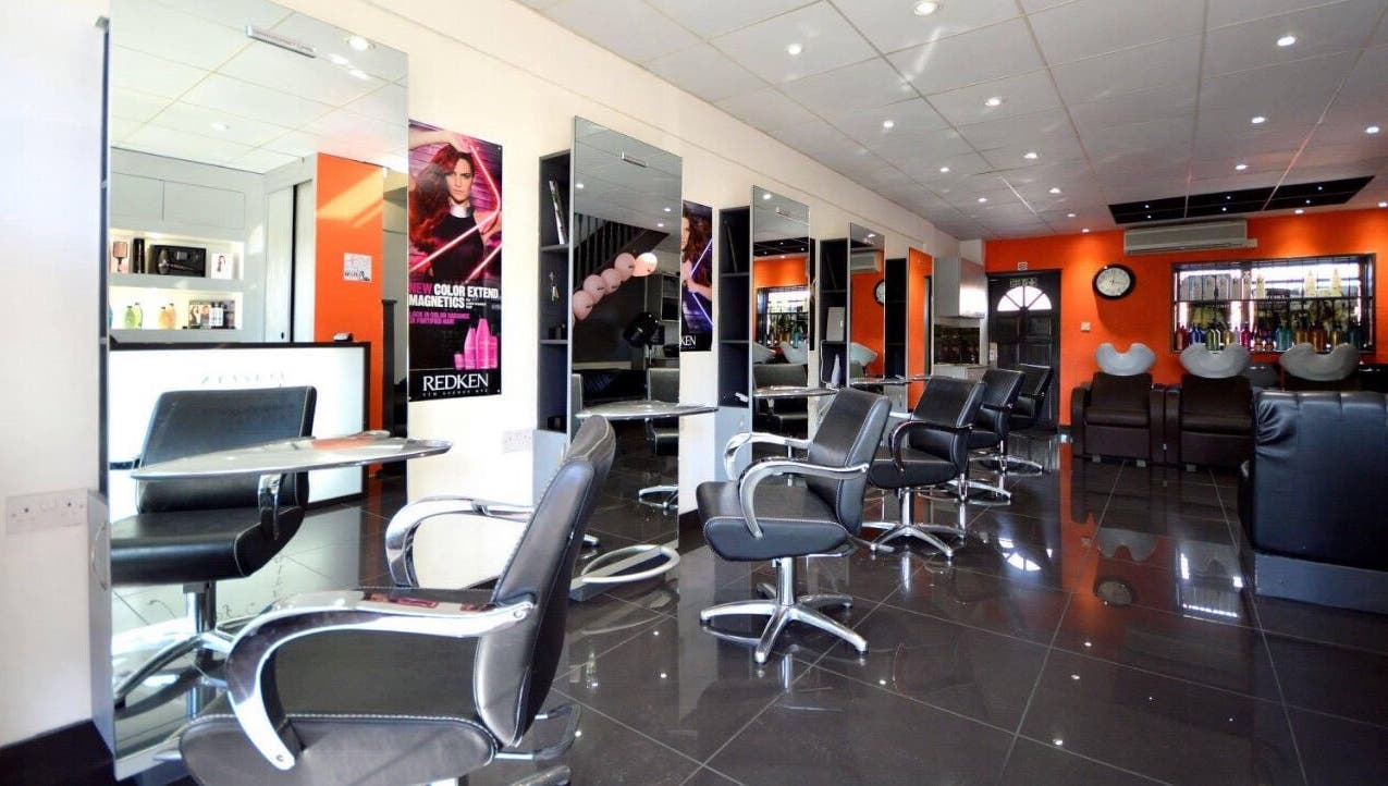 Modern salon at Italian Inspiration, Woking, England, GB with stylish chairs and mirrors.