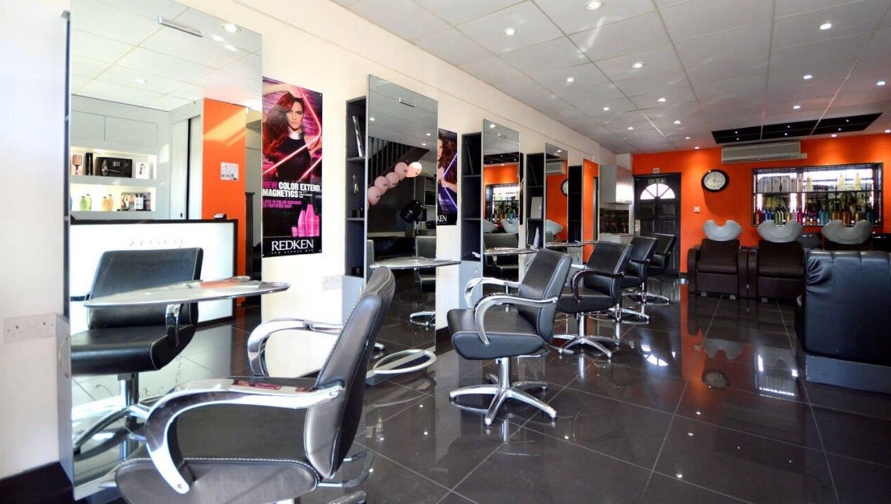 Modern salon at Italian Inspiration, Woking, England, GB with stylish chairs and mirrors.