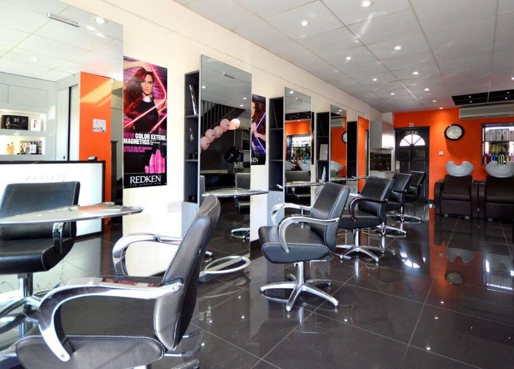 Modern salon at Italian Inspiration, Woking, England, GB with stylish chairs and mirrors.