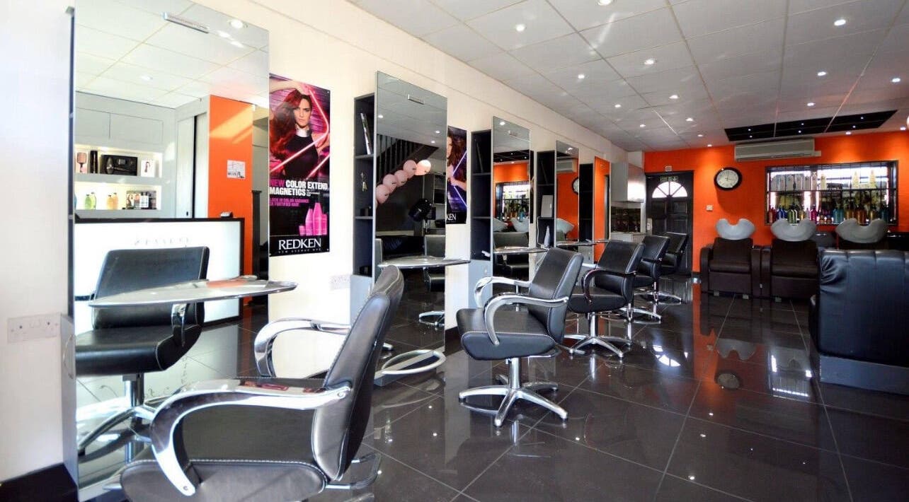 Modern salon at Italian Inspiration, Woking, England, GB with stylish chairs and mirrors.