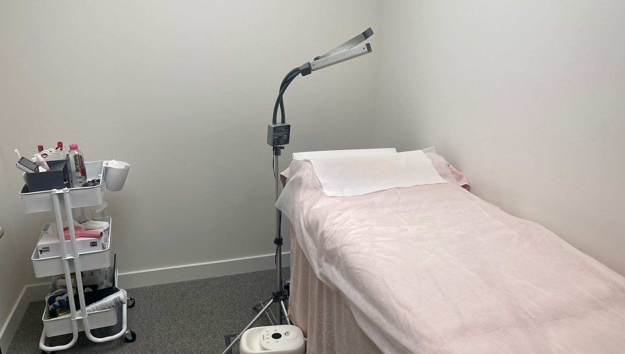 Private treatment room at (Closed) Battersea - Wish Beaute, London, England, GB, with a bed and equipment.